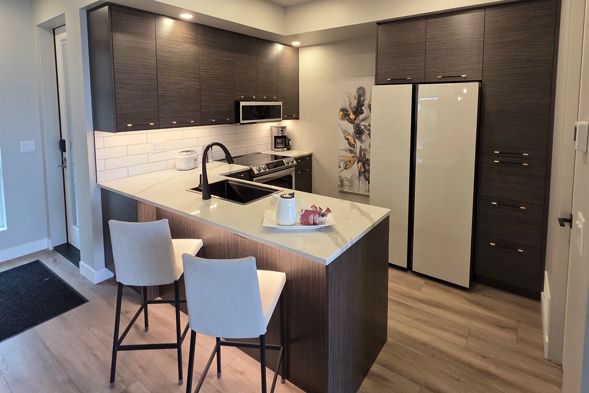 Chef's Kitchen. Higher end appliances and dishware. Bar seating.