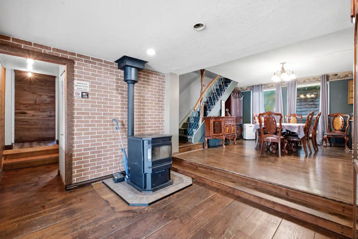 Open living and dining area with wood stove