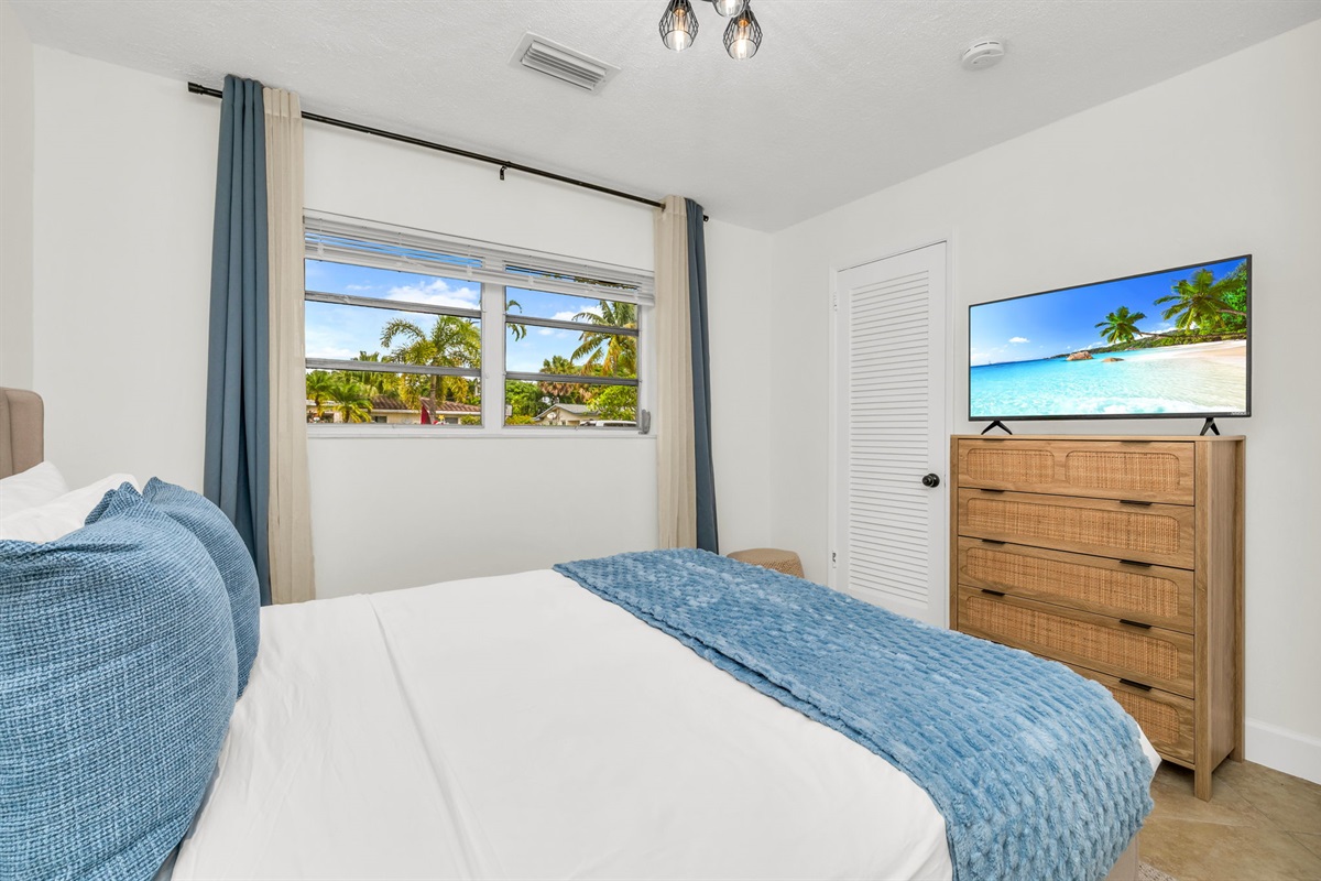 2nd Bedroom: A bright and welcoming retreat featuring a plush queen bed, soft layered linens, and coastal-inspired décor. This room offers ample storage, and warm natural light.