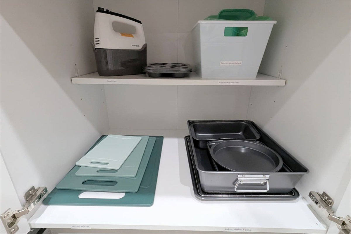 Kitchen also has cutting boards, baking pans, hand mixer, and food storage containers. 