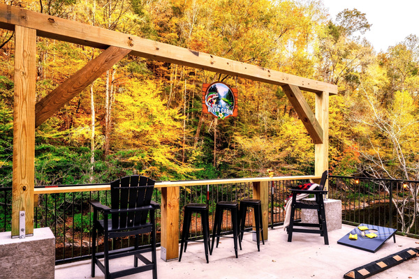 Check out this impressive post & beam that also functions as a bar table area that overlooks the "Little Pigeon River". Make it your one-of-a-kind experience while listening in to the rushing sound of water while watching wildlife in front of you.