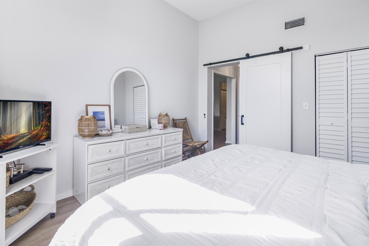 Relax in the serene comfort of the main bedroom, featuring plush bedding, peaceful views, and a private en-suite bathroom for added convenience and privacy.