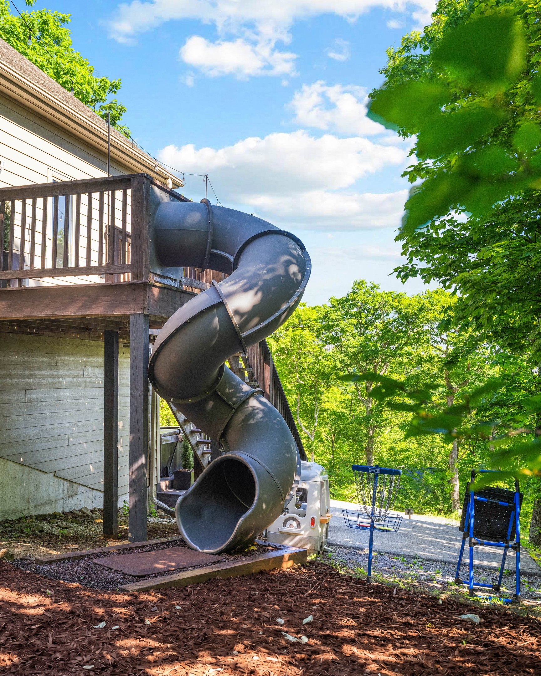 Tucked into the trees next to the entrance deck, the slide and play area give the home its own little adventure zone — perfect for keeping the fun going between hikes, ski runs, and hot tub time.