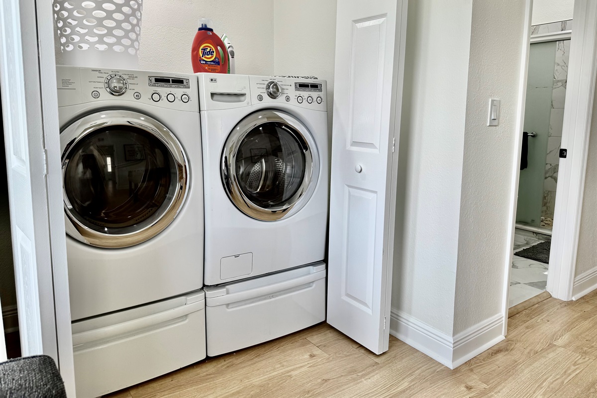 A dedicated laundry space with front-loading machines, bright lighting, and starter detergent provided to keep you feeling fresh throughout your stay.