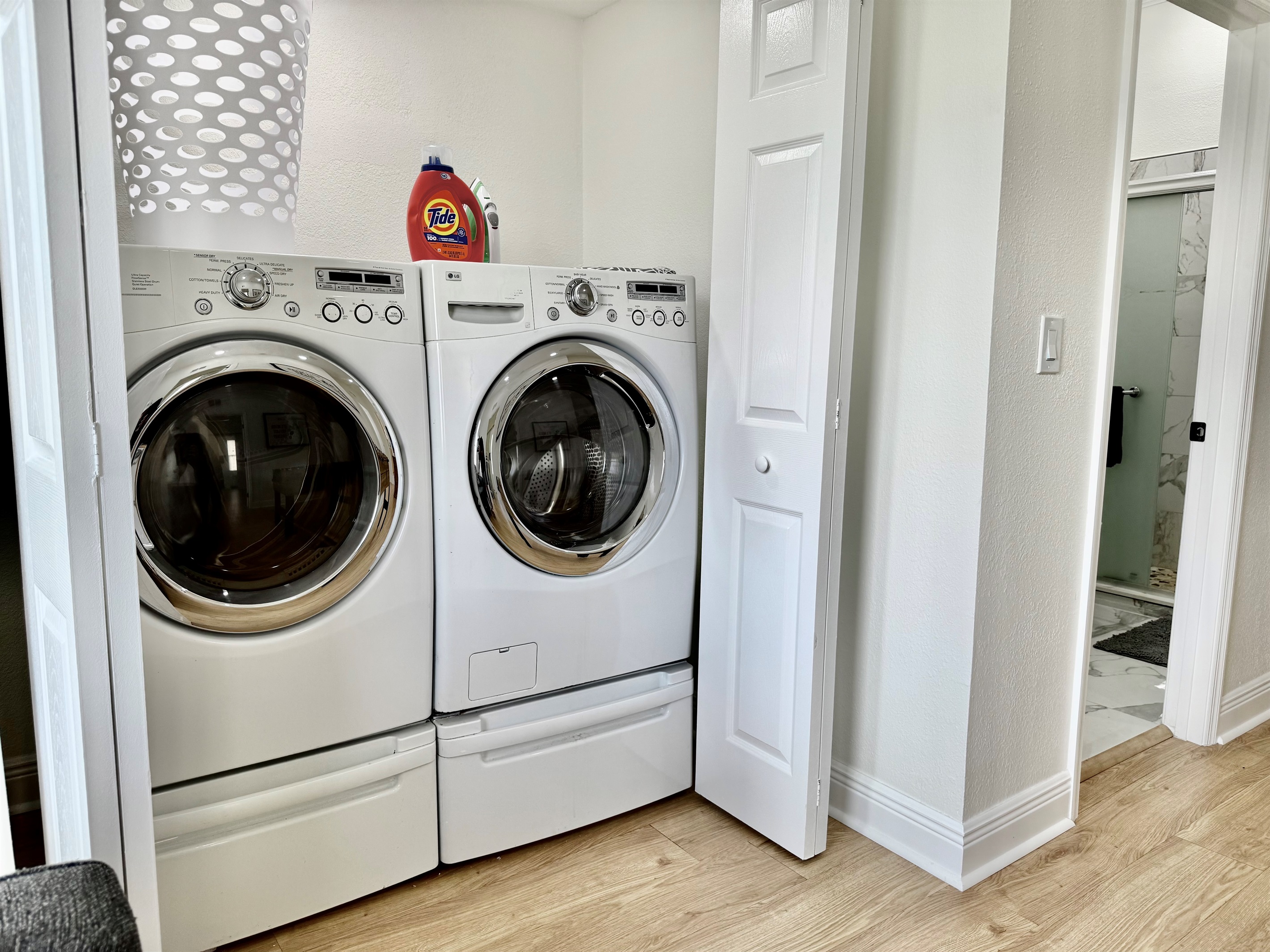 A dedicated laundry space with front-loading machines, bright lighting, and starter detergent provided to keep you feeling fresh throughout your stay.