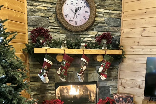 Feel the warmth of the season by the crackling fireplace, stockings hung with care and the scent of pine filling the cabin, where every spark brings a little holiday magic.