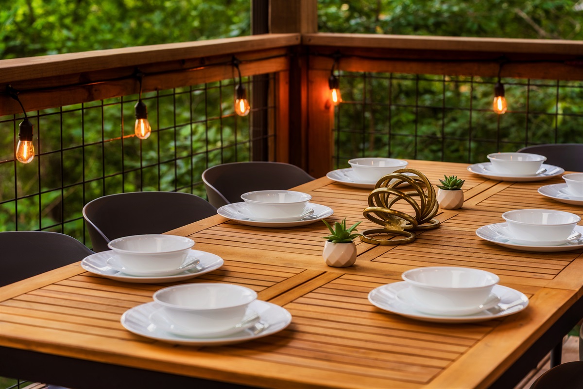Dine on the back deck with string lights and nature views  