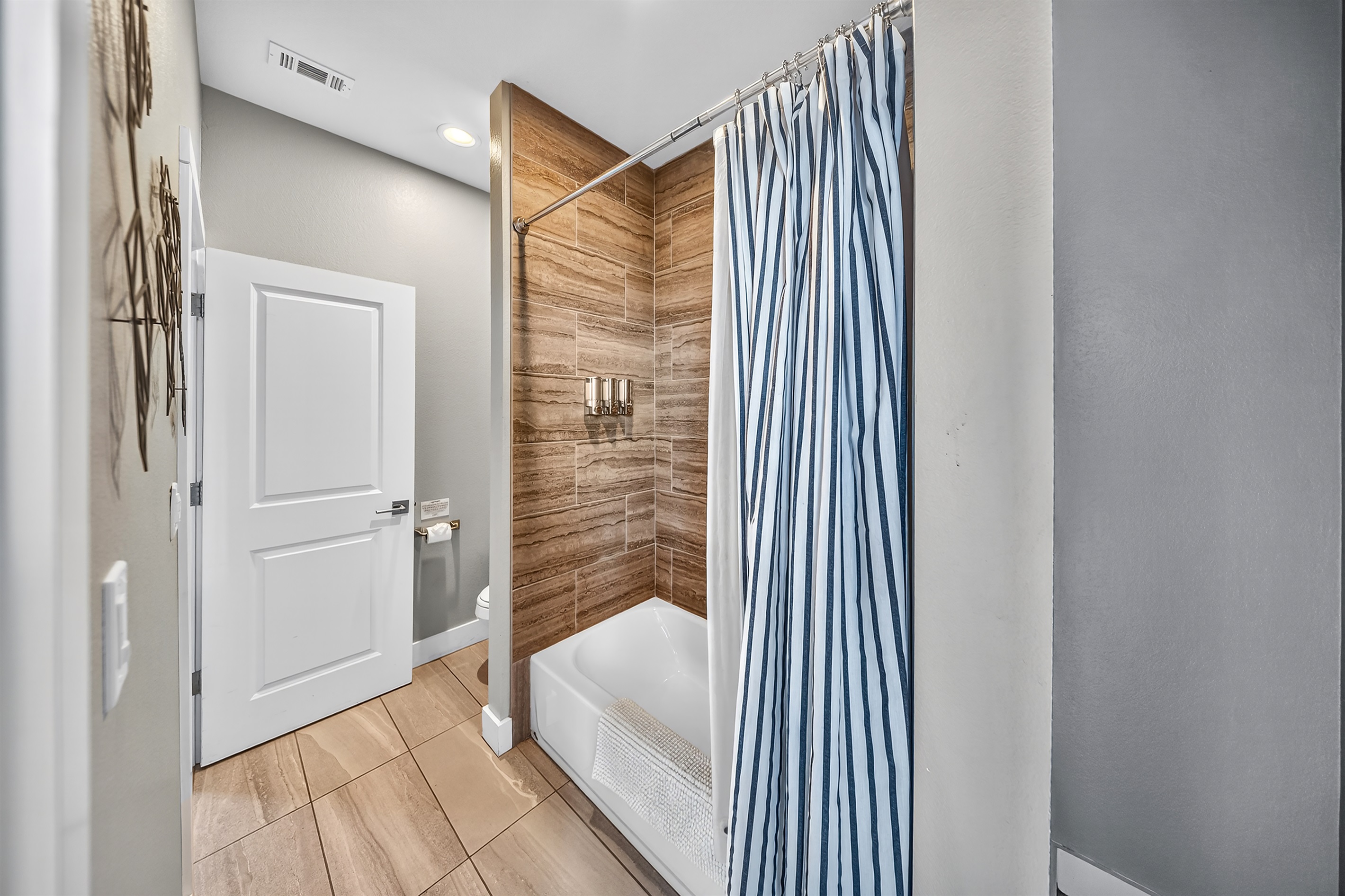- Guest bathroom with spacious vanity and bright modern finishes - Soft lighting enhances morning routines for your lake getaway - Clean design supports families enjoying comfortable stays