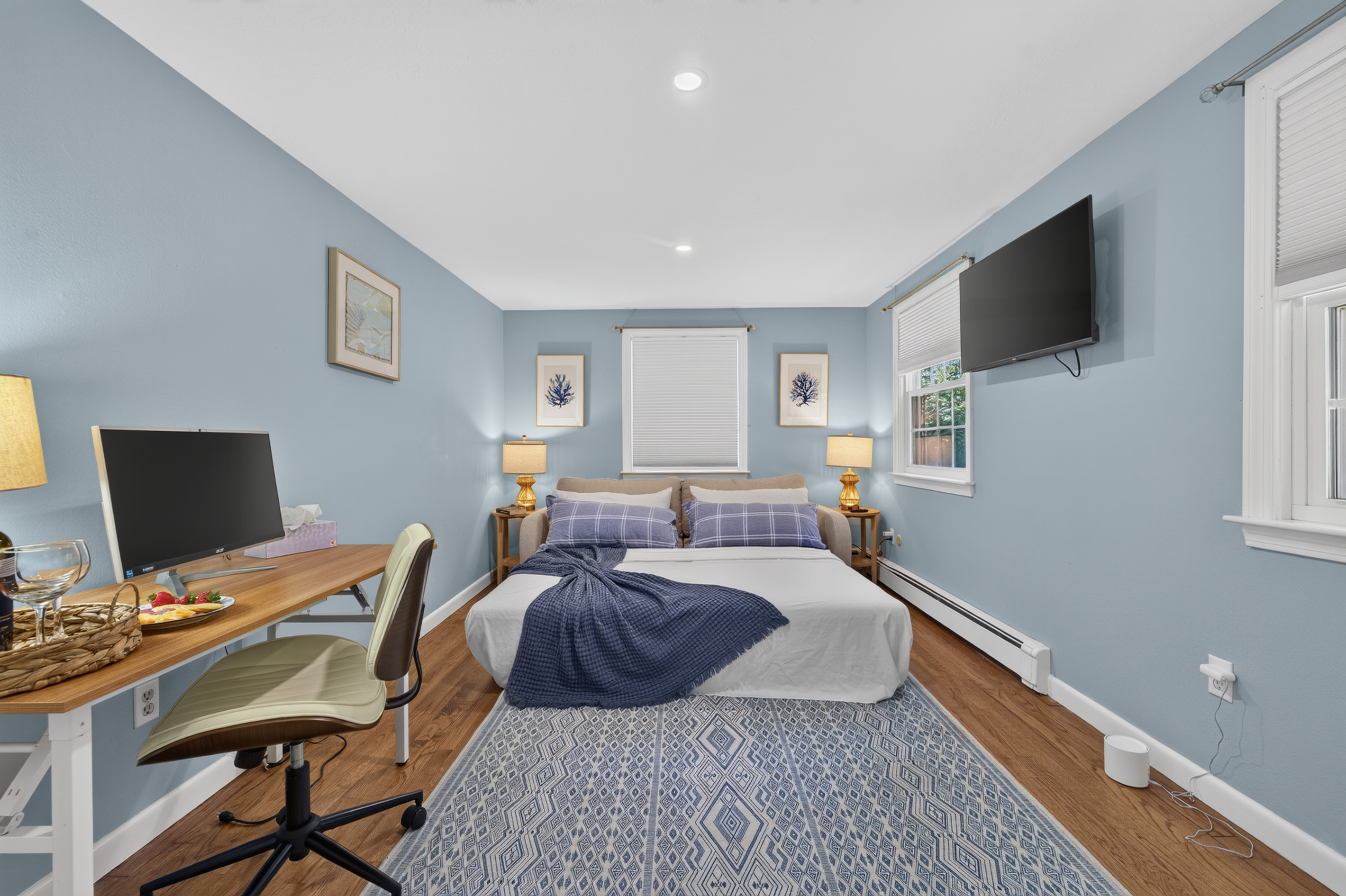 Thoughtfully furnished bedroom offering space to rest and stay productive.