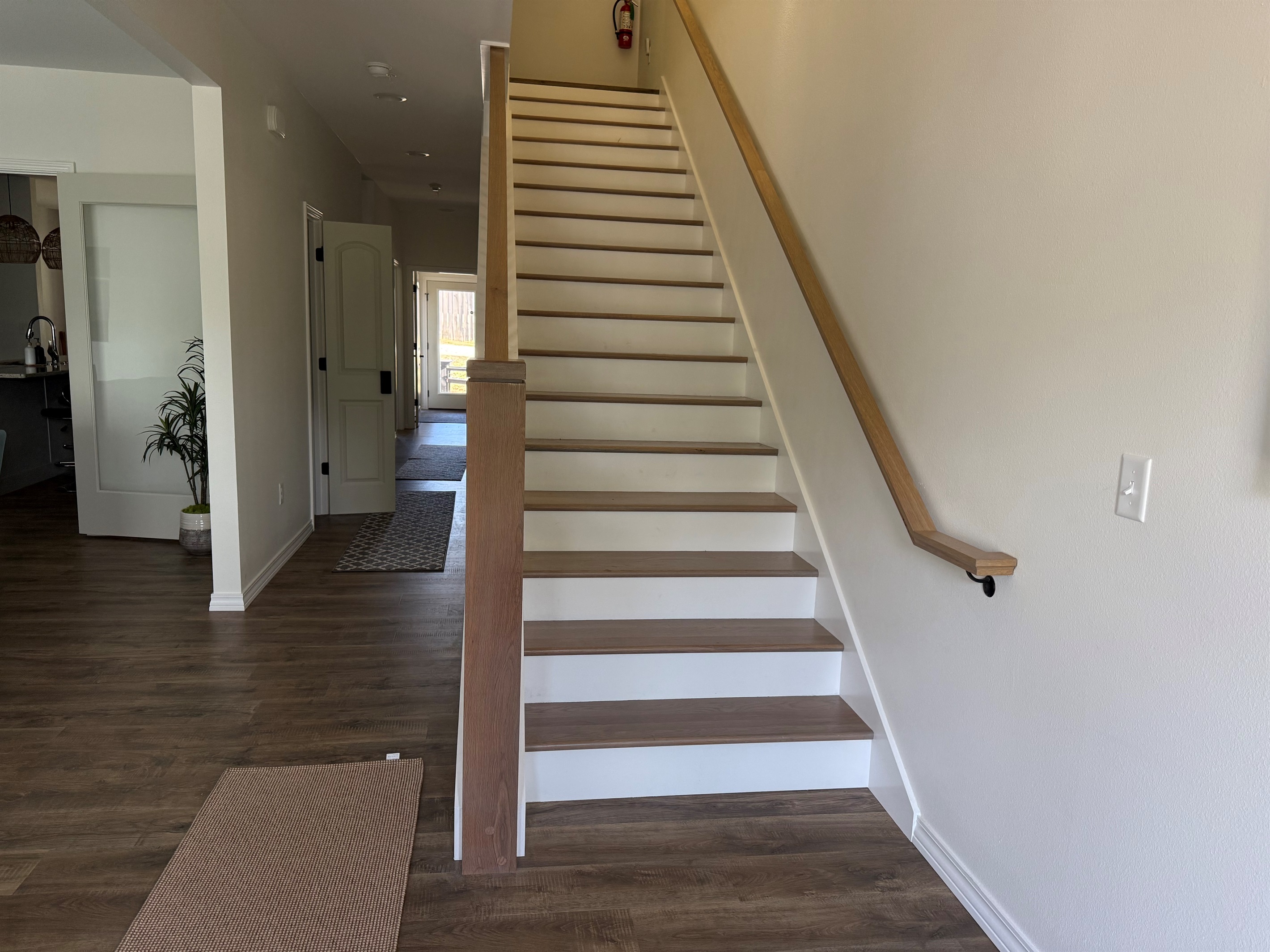 Open concept stairs and hallway make is a custom home