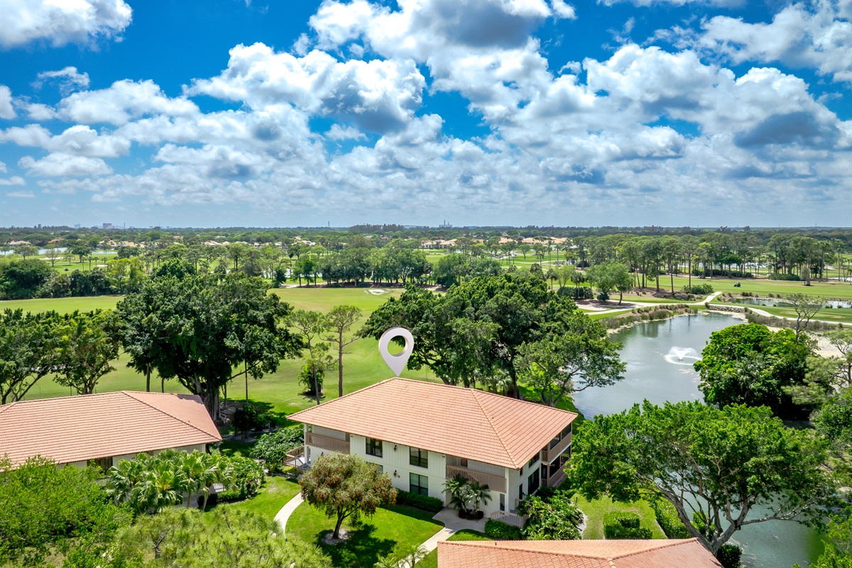Aerial view showcasing lush golf course, water features, and serene surroundings