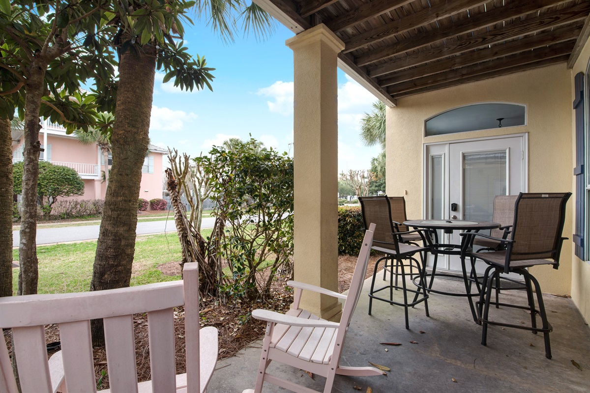 Covered patio with outdoor dining and garden views