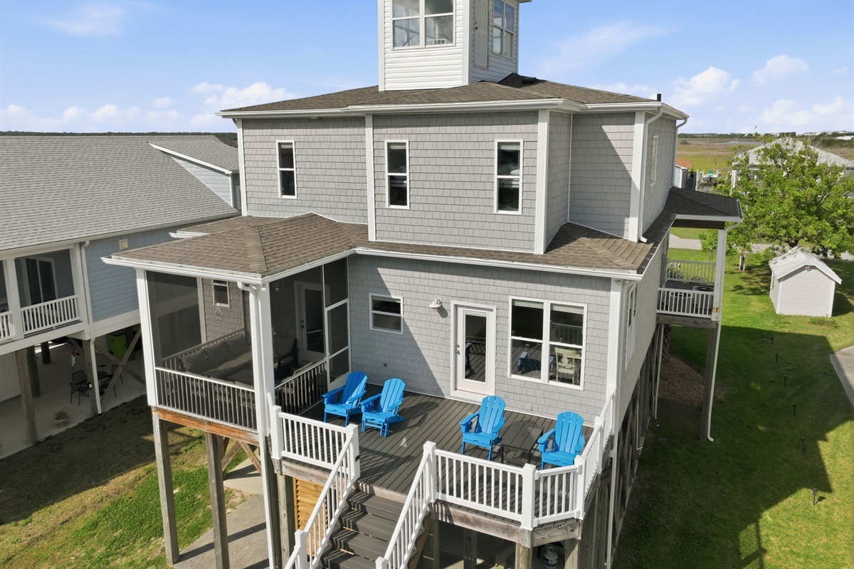 Unwind on the back deck with outdoor seating, canal views, and a screened-in lounge area