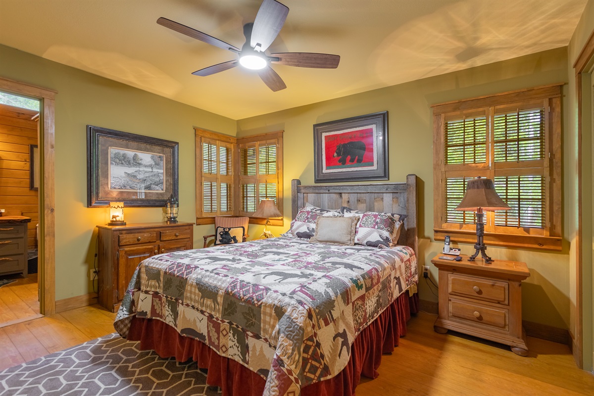 The primary bedroom offers a peaceful retreat with warm cabin touches and a comfortable layout designed for relaxation.