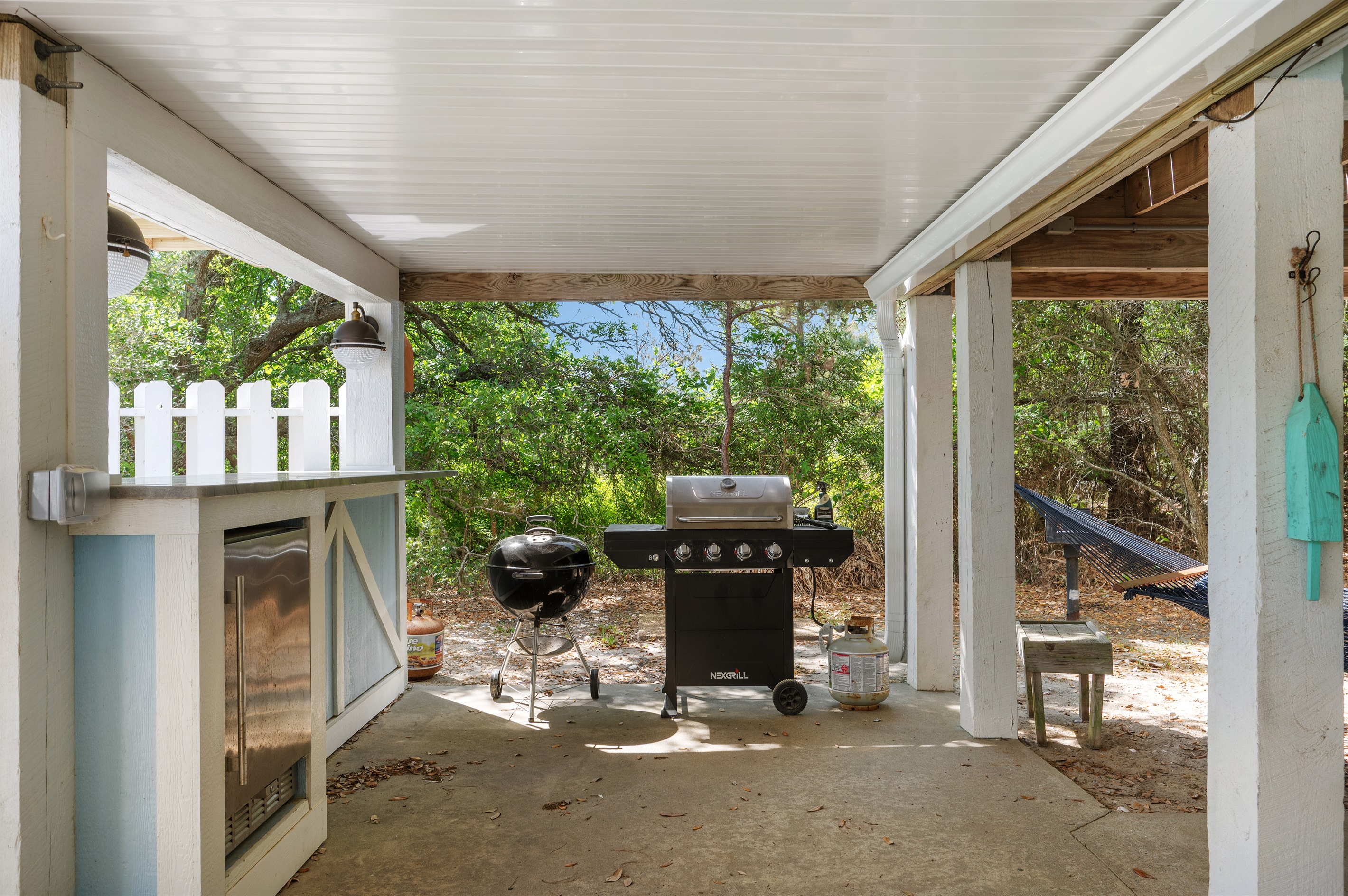 Covered grilling area under the home for shaded cookouts and outdoor gatherings.