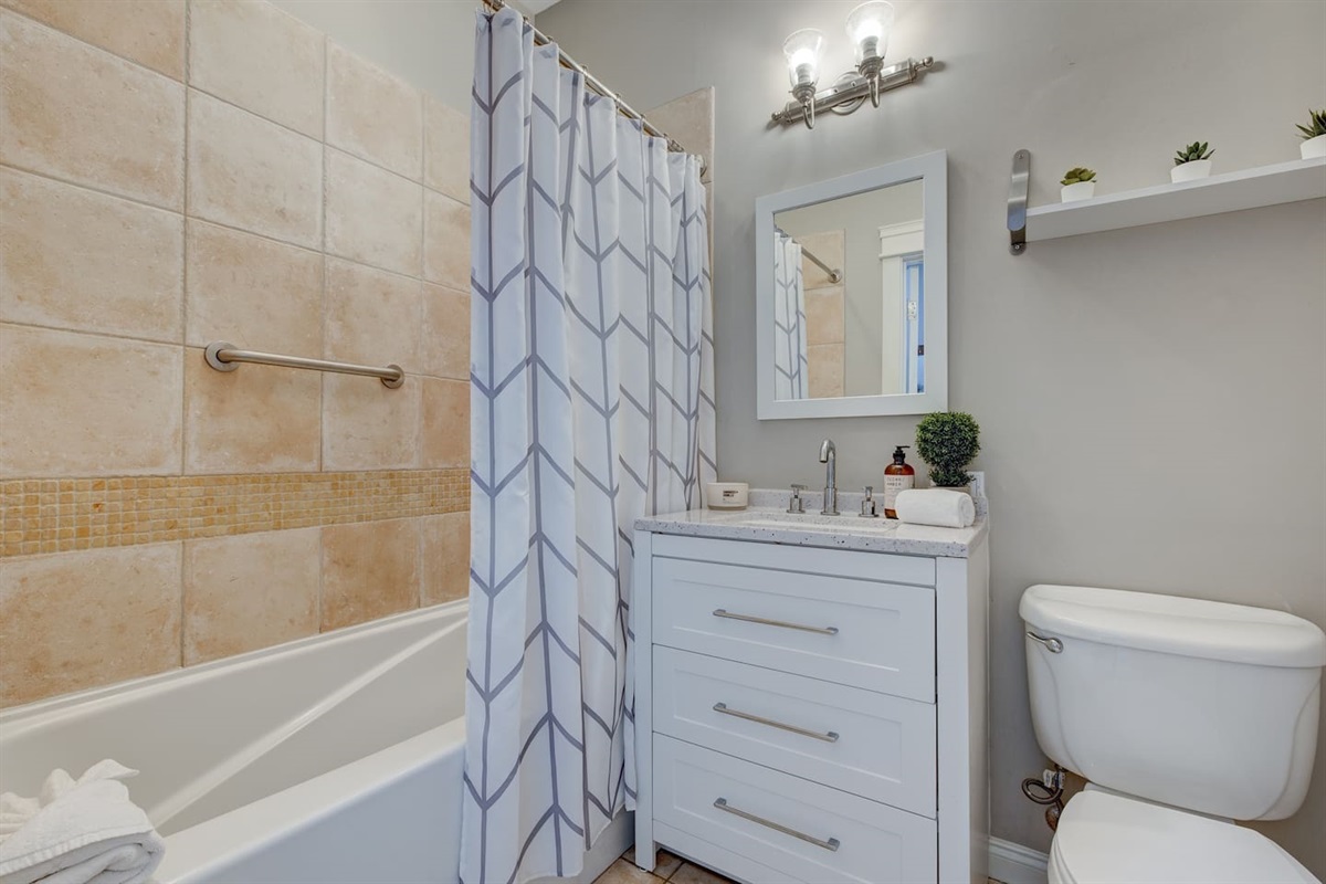 Our full-size bath has a tiled shower/tub combo.