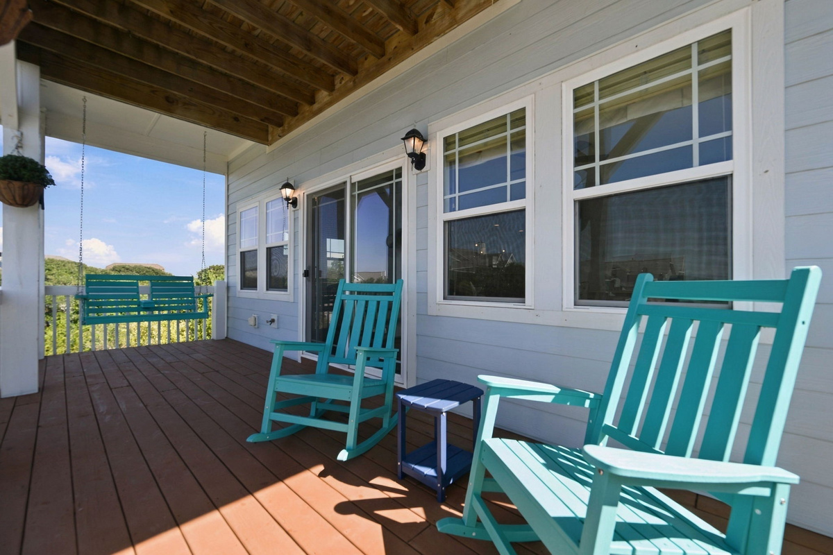 Enjoy your morning coffee or unwind after a beach day in the turquoise rocking chairs or porch swing on the covered porch