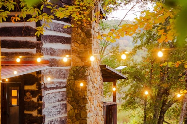String lights glow around the cabin, setting the stage for a cozy evening.