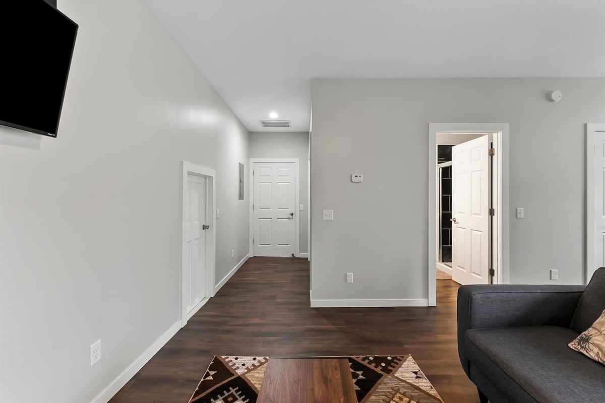 A simple yet elegant setup featuring warm wood flooring and contemporary furnishings.