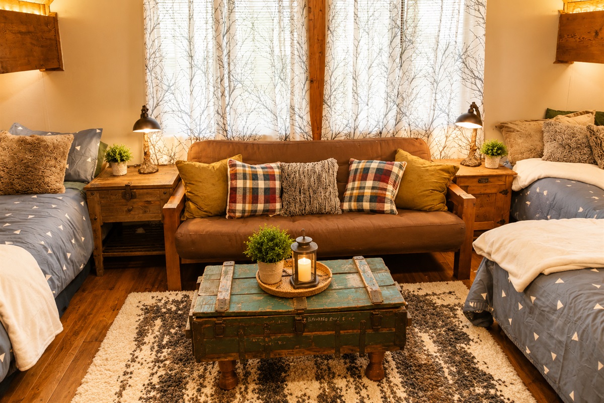 Our Upstairs loft area is both a sleeping area and a second hang out spot.  There are 4 beds (3 twin & one full) and the couch folds down into a queen size sleeper futon.  There is also a tv in the loft.  It is an open loft area (half walls only). 