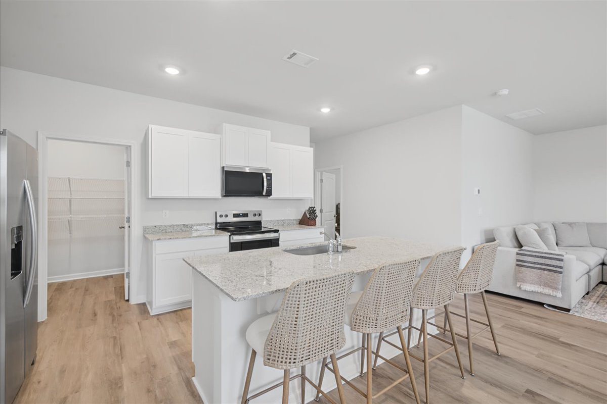 Fully equipped kitchen with stainless appliances and a large walk-in pantry