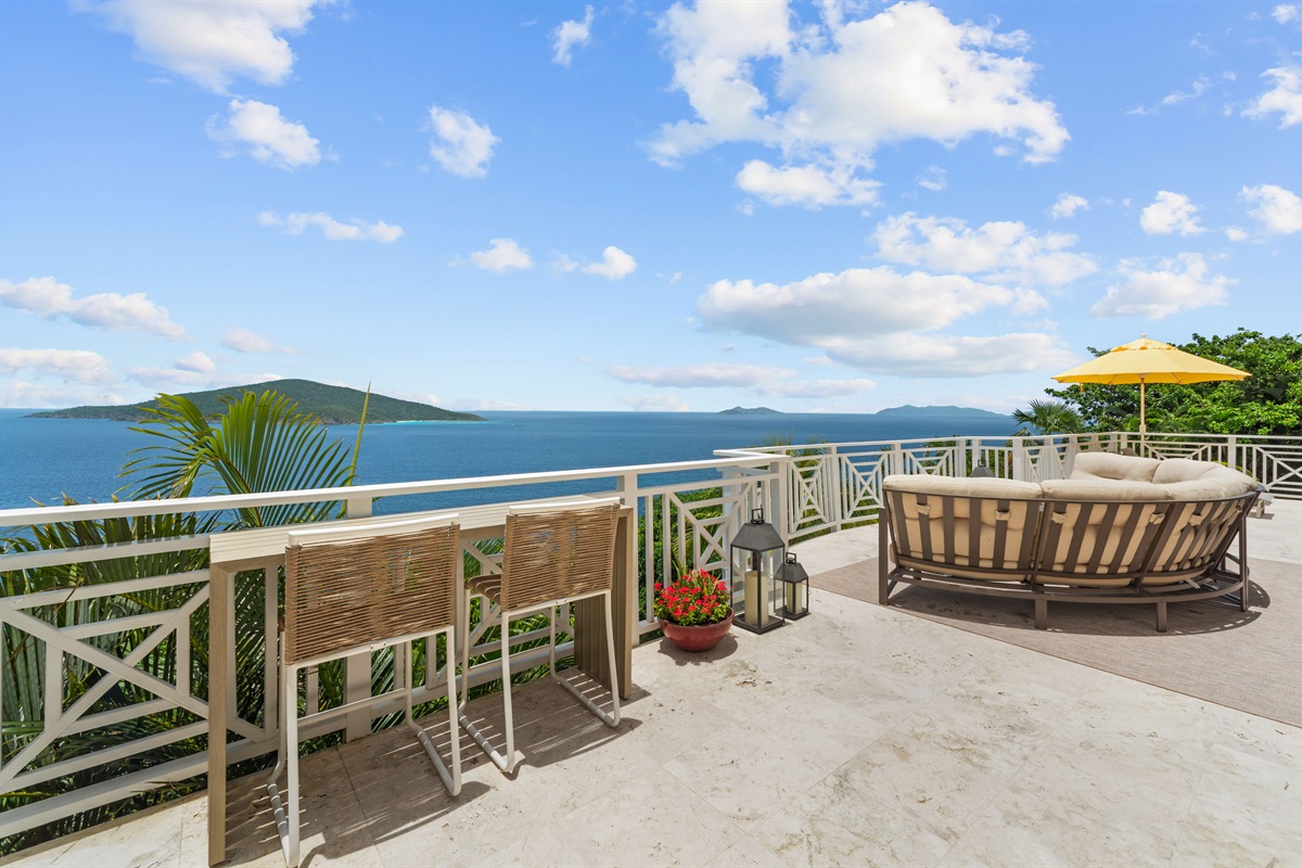 Upper-level balcony with panoramic ocean views, ideal for coffee at sunrise or nightcaps under the stars.