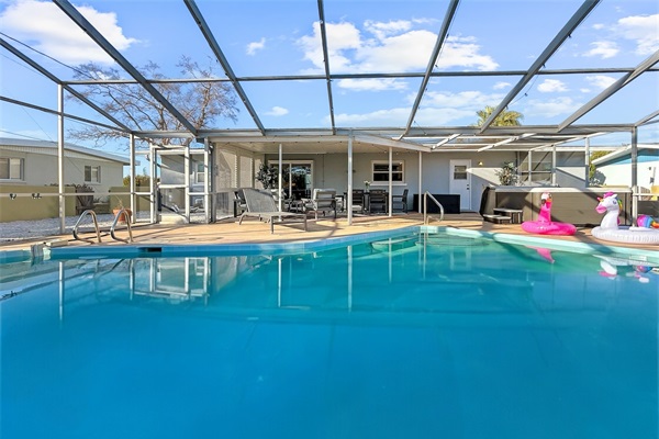 Sparkling private pool with a spacious patio setup—made for pool days, meals outside, and evening unwind.