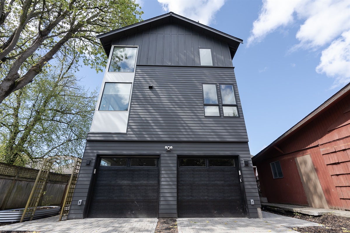 We provide 2 parking spots. You can park in front of the left garage or on the left (not pictured). Garage space is NOT included. Please note that this ADU is accessed from the side alley / rear of the lot.