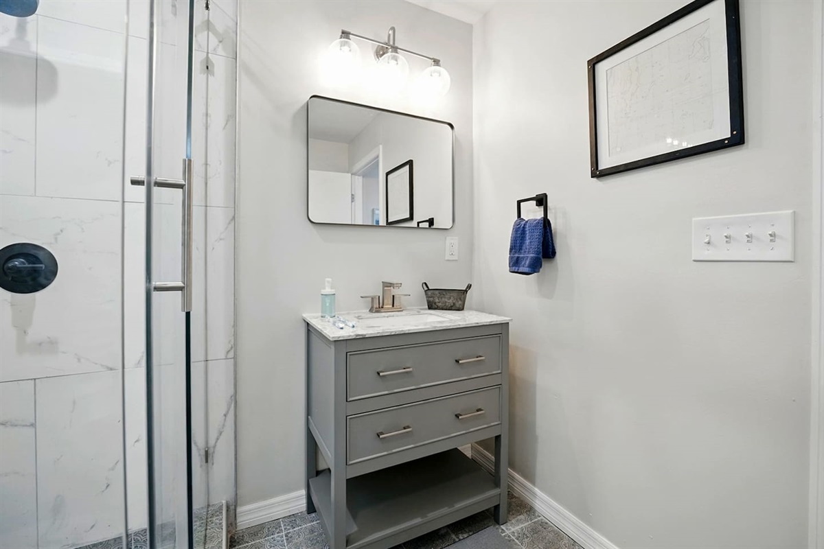 Fresh bathroom w/ walk-in shower & crisp tile