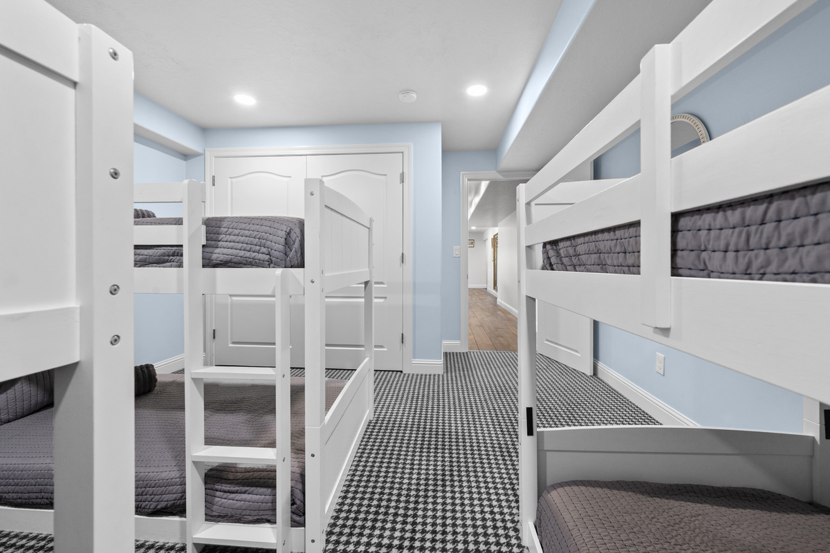 This bright bunk room provides four individual sleeping spaces, built-in ladders, and a large closet for convenient storage during your stay.