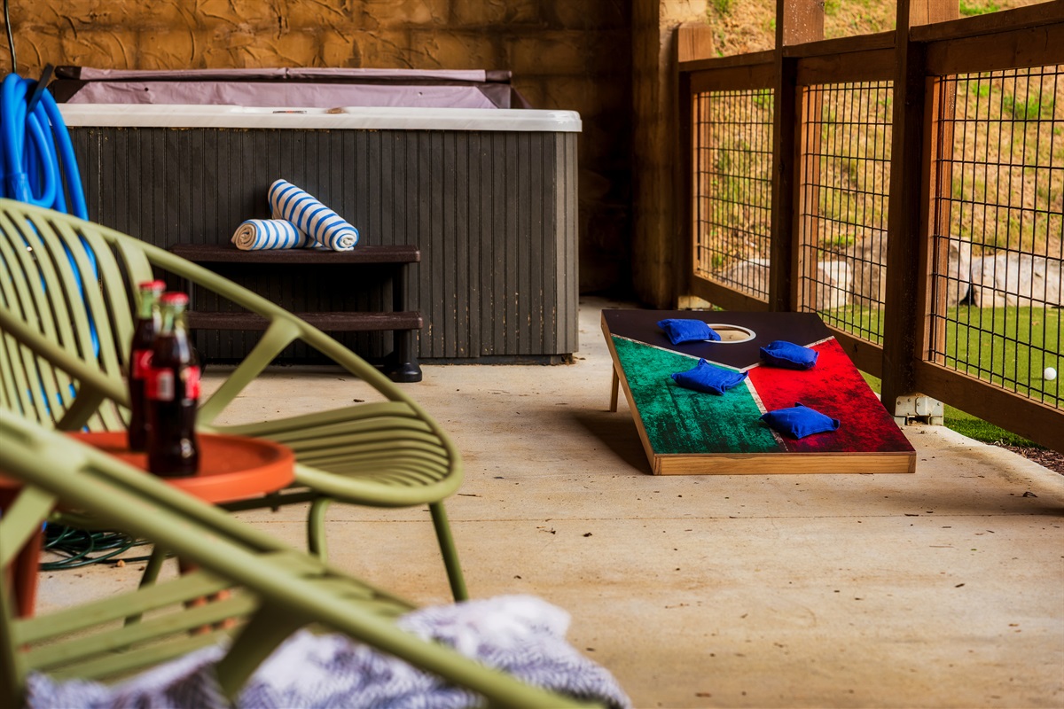 Lower deck with  hot tub and cornhole game