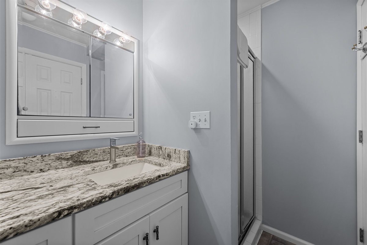 Spacious vanity area with ample counter space and well-lit mirror for easy mornings