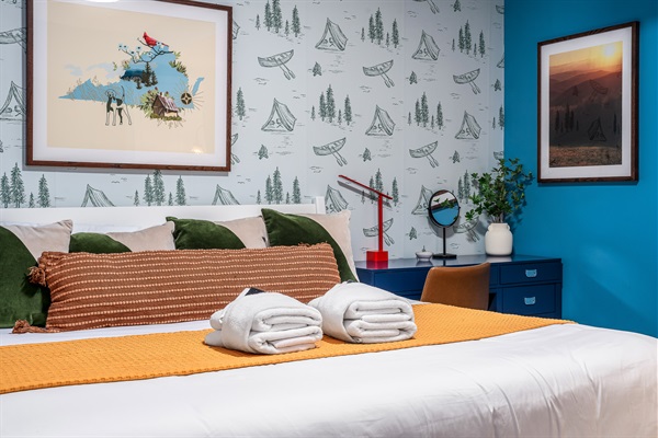 A cozy, camp-inspired room that kids and adults both love — comfy bedding, fun wallpaper, and plenty of charm.