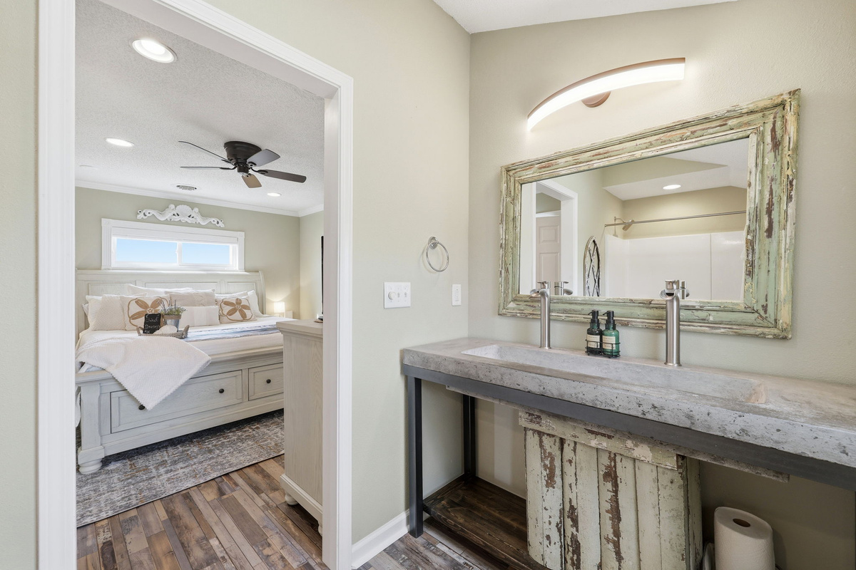 A one-of-a-kind rustic sink adds character to this thoughtfully designed ensuite bathroom