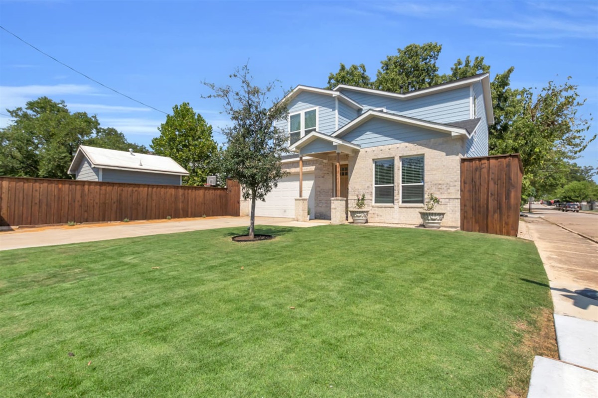 Welcoming modern home with fresh landscaping and stylish curb appeal.