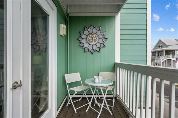 Front porch off primary bedroom with bistro set. Perfect for watching sunrise off the coast. 