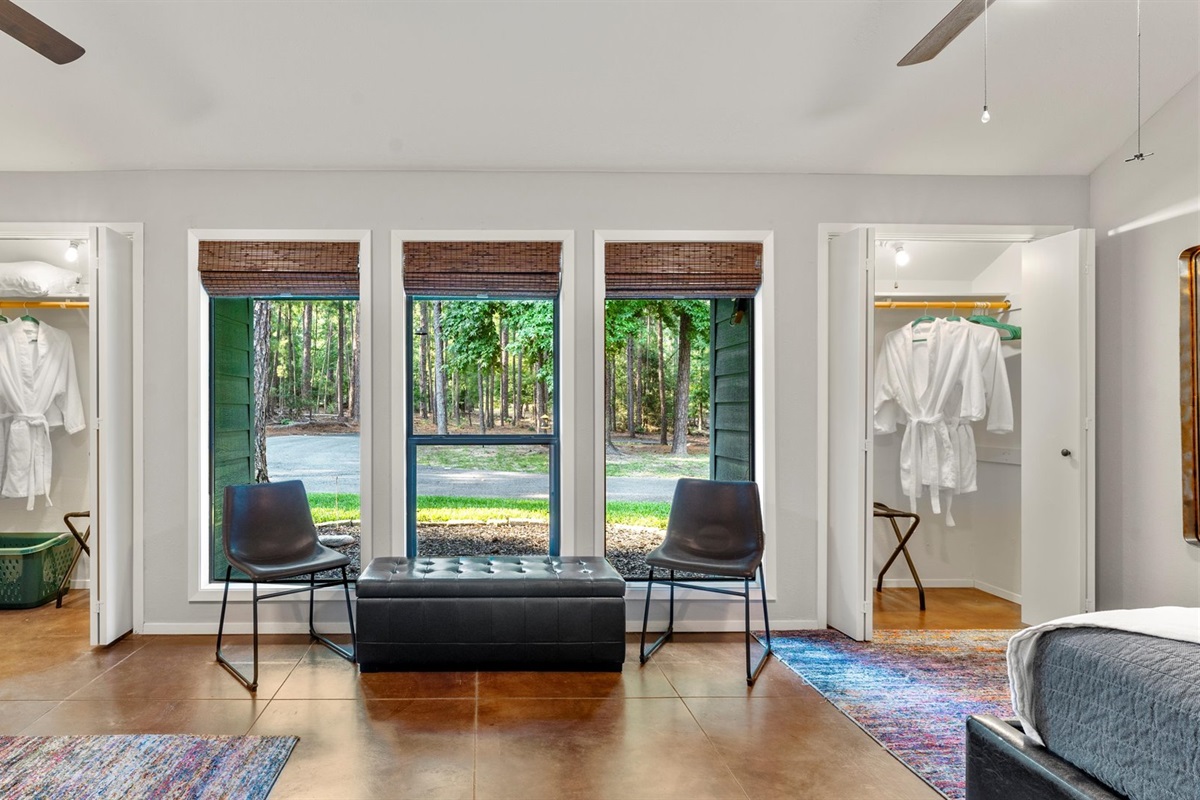 A bright and inviting view of the Trundle Bedroom! Featuring cozy seating, beautiful natural light, and well-appointed closets with plush robes, this space is designed for comfort and relaxation.