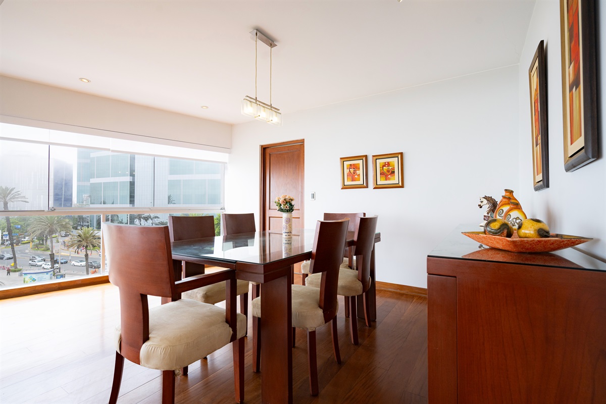 Dine Above the Ocean: A spacious dining area integrated with floor-to-ceiling glass, showcasing the vibrant Malecón and the coastline