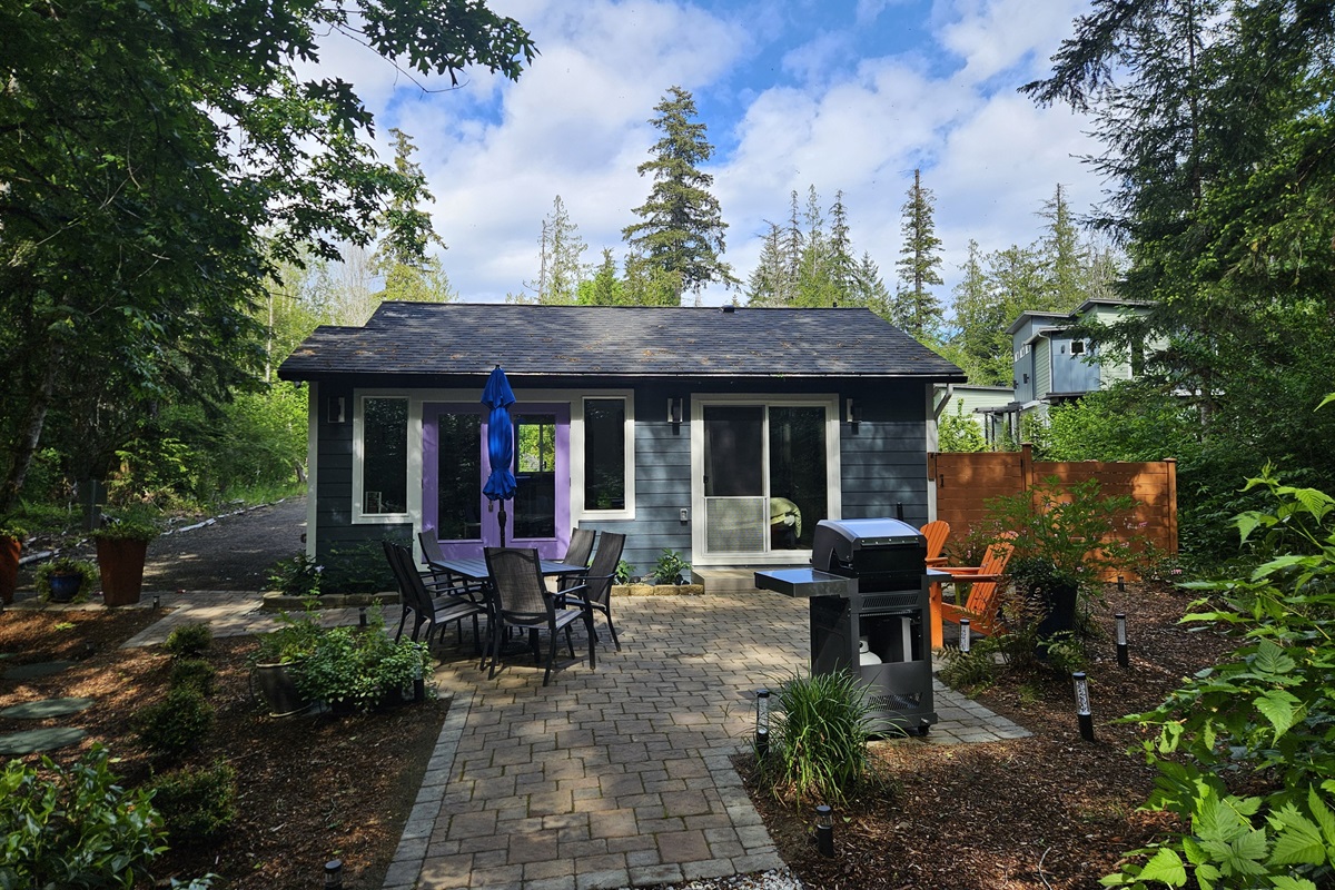 650 sq ft patio with Adirondack chairs, dining table for 6, and stainless steel commercial infrared grill for summer cookouts.