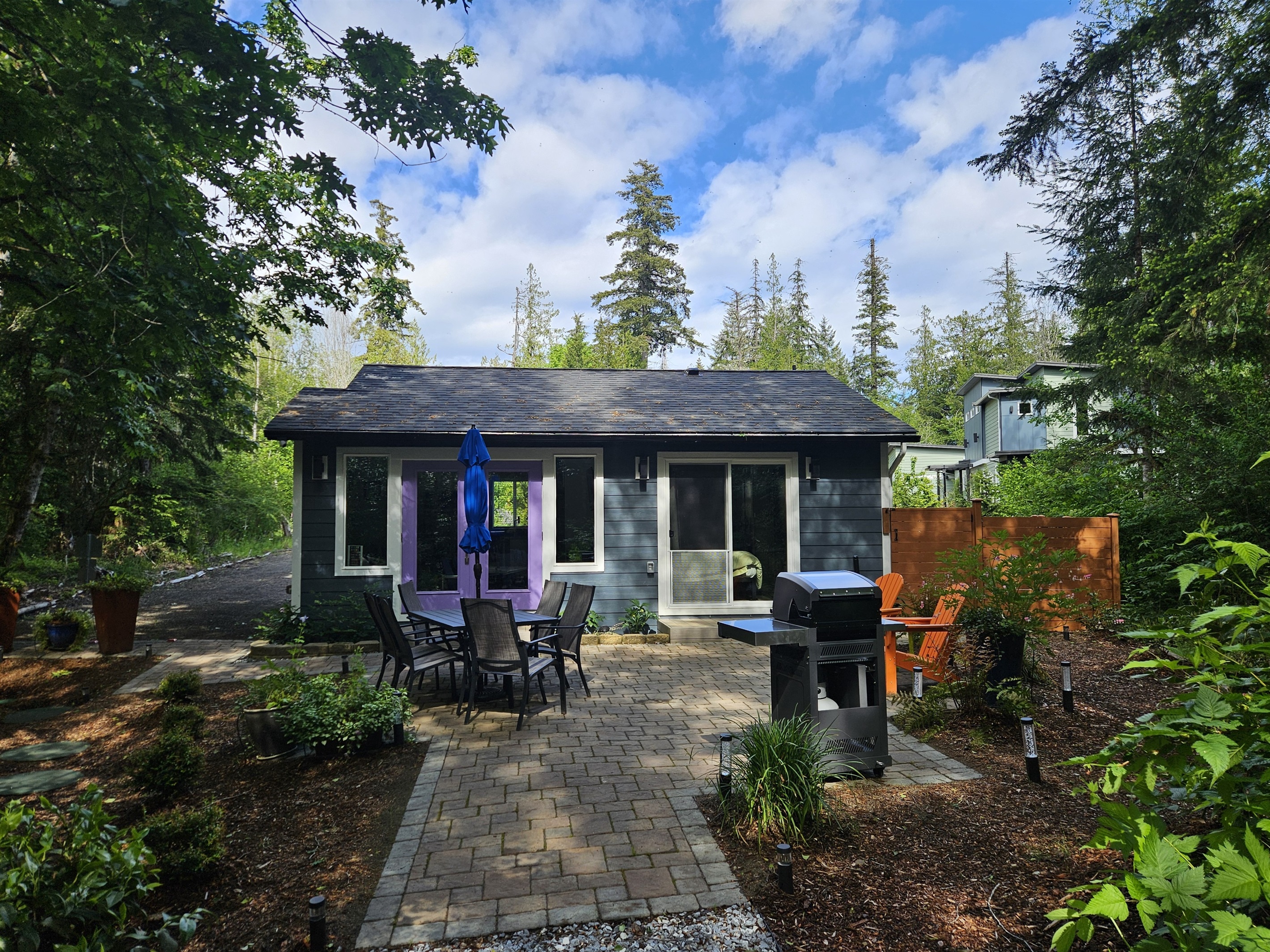 650 sq ft patio with Adirondack chairs, dining table for 6, and stainless steel commercial infrared grill for summer cookouts.