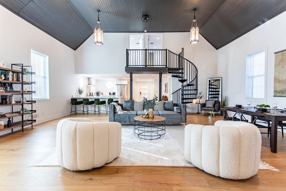 Bright living area with a clear view of the stairs, enhancing the open layout and adding a touch of elegance to the overall design.