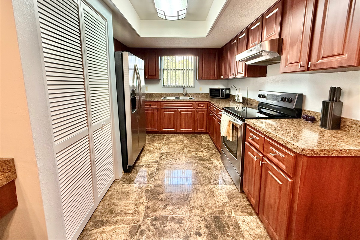 Paired with the rich cabinetry and glossy marble-look tile floors, the space feels both luxurious and functional.