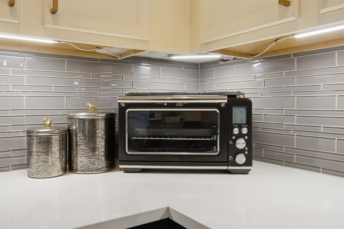 Toaster Oven with Air Fryer plus everyday cooking basics including a Toaster, Electric Kettle, and canisters on the counter.
