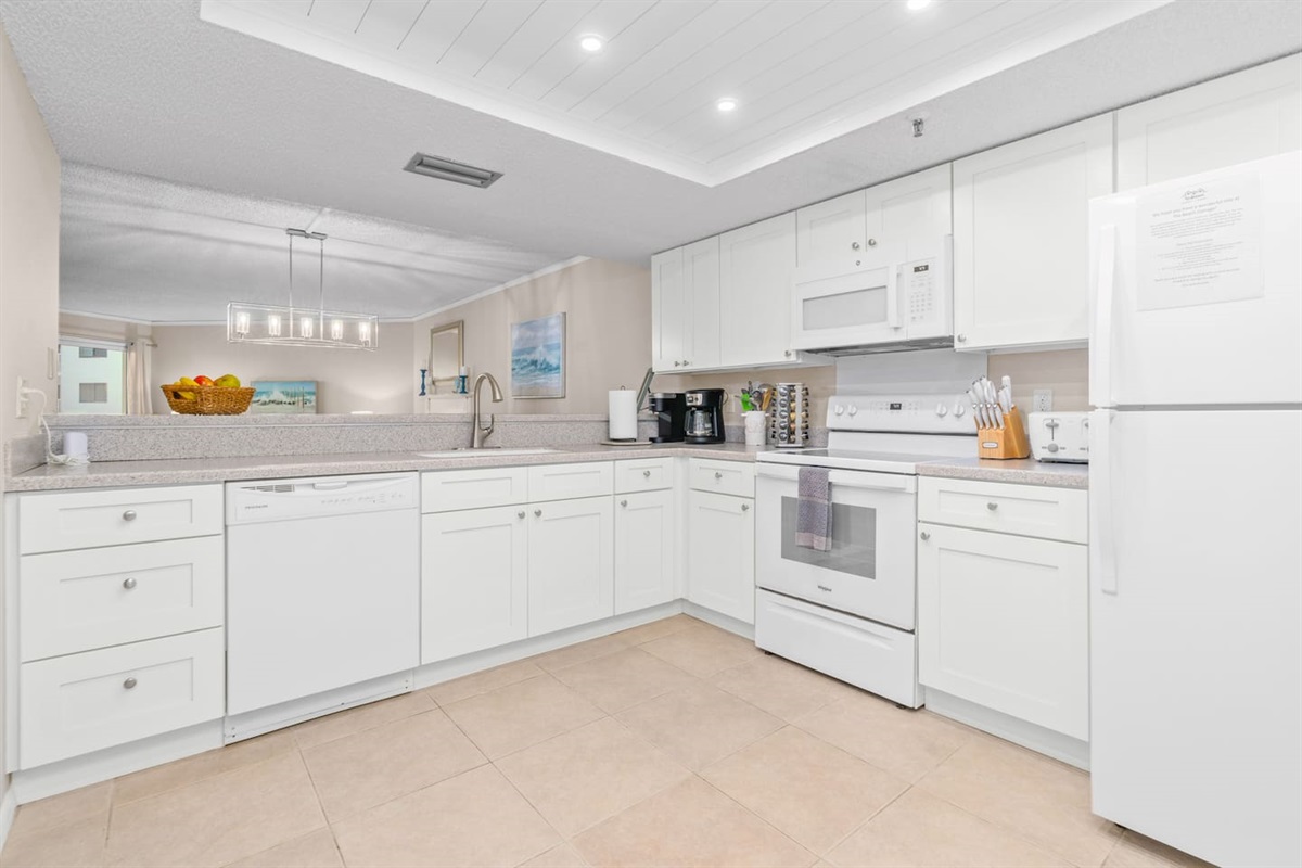 Fully stocked custom kitchen open to the living room. 
