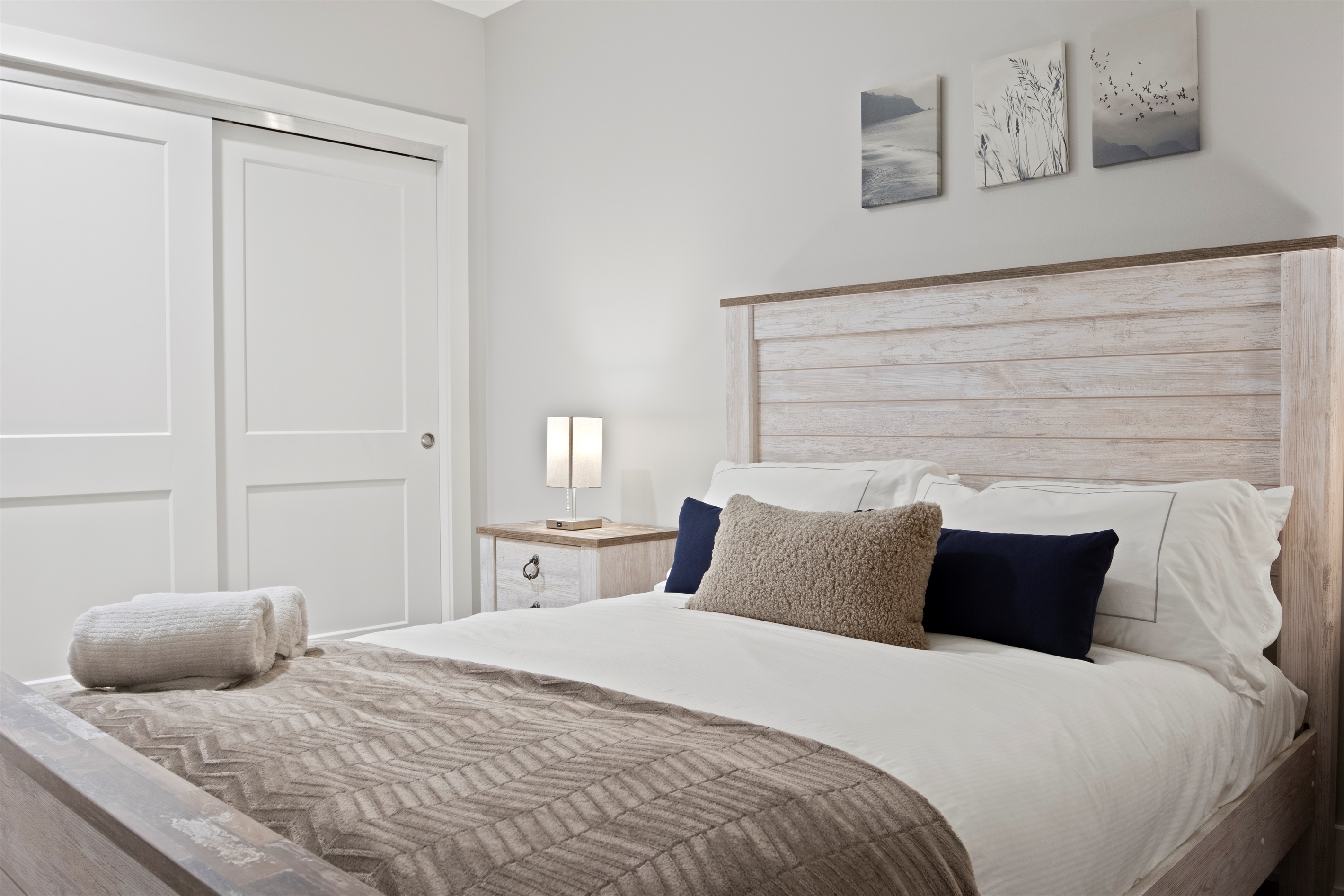This serene guest room offers comfort and charm with a plush bed, stylish wood furnishings, and ample closet space — ideal for your Finger Lakes getaway.