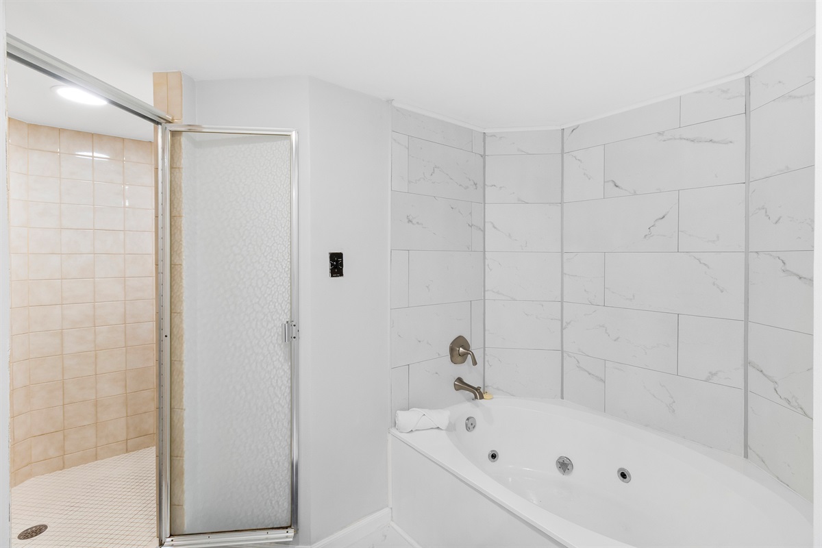 Primary bathroom, bathtub, and walk-in shower.  Jets in garden tubs are non-functional.