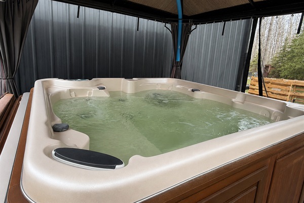 Private hot tub surrounded by trees for relaxing soaks