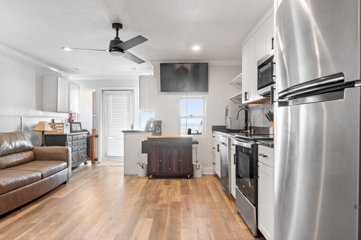 The 1st Floor features another Living Room w/ 50" Smart TV, Pre-Loaded Game Console, Queen Sleeper Sofa, Murphy Bed, a Kitchenette, and Patio Access - Great for the Kids or Two Families!