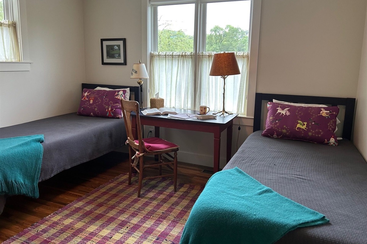 The loft bedroom features extra long twin beds & a writer's desk with good Wifi