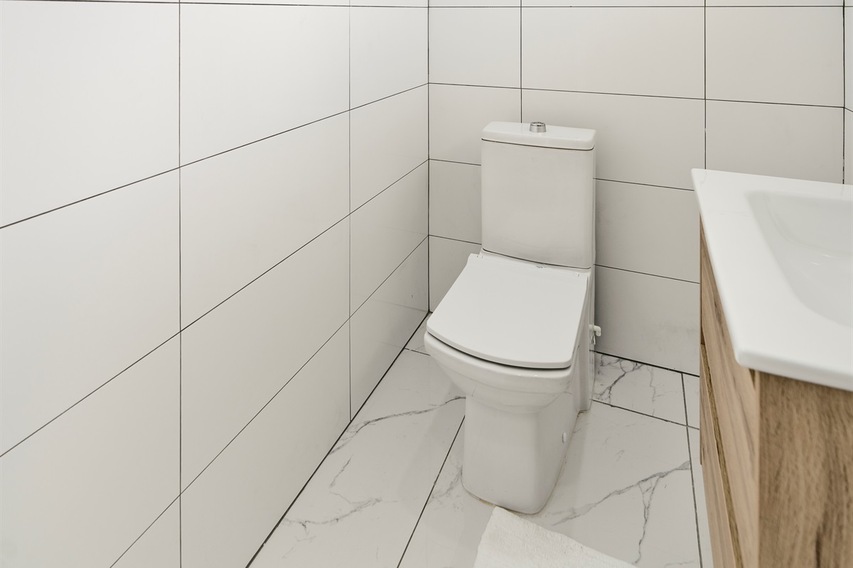 Minimalist Half Bath with Contemporary Toilet & Bright White Tile